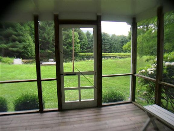 screened porch lookiing at pond