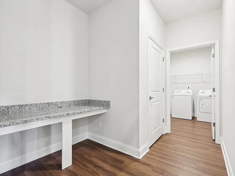 Dedicated desk area with convenient access to the laundry room.