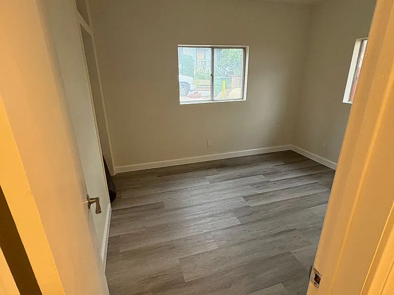 End of hallway, bedroom on the left.