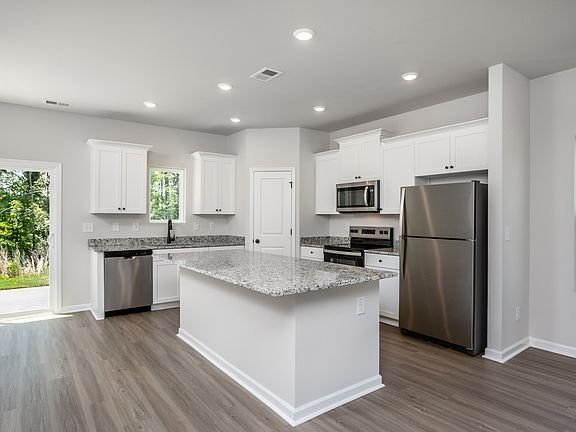 The kitchen opens to the family room and dining room.