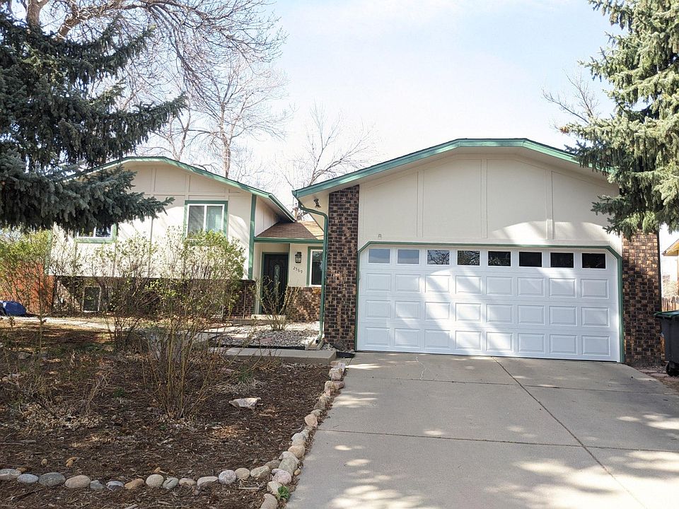 The front of the house welcomes you with low-maintenance landscaping and wonderful trees that provide shade during the summer!