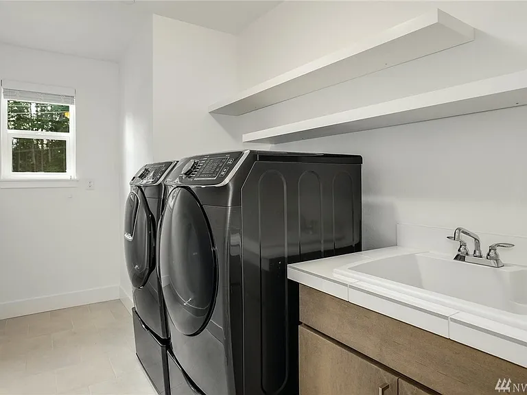 Laundry room with sink, top of the line washer and dryer