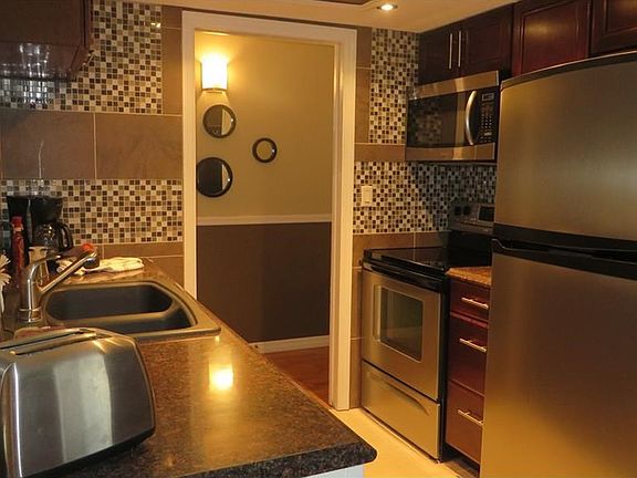 Beautifully updated Kitchen w/stainless appliances, cabinets, counters and tile backsplash.