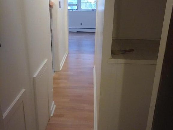 HALLWAY WITH STORAGE AREA BY THE BEDROOM.