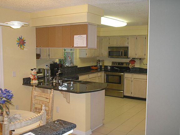 beautifully reappointed kitchen with granite & ss appliances