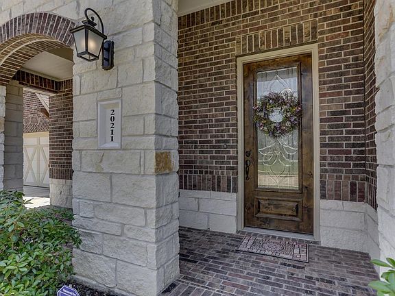 Stunning brick and stone elevation and wonderful covered front porch to greet your guests.