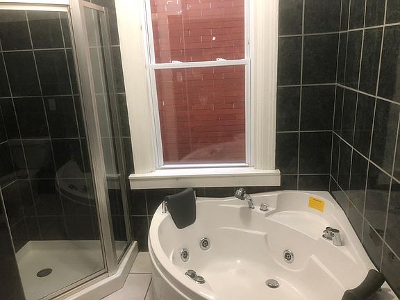 Bathroom has a shower and whirlpool tub.