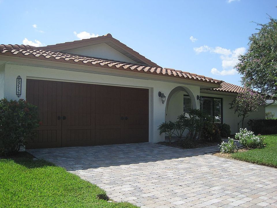 Custom garage door and Belgard paver drive