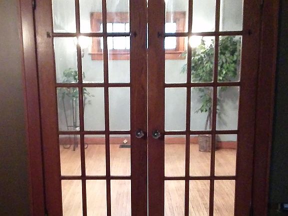 The dining room leads to the kitchen, upstairs rooms, and also the side entry door off the driveway as well as the basement.