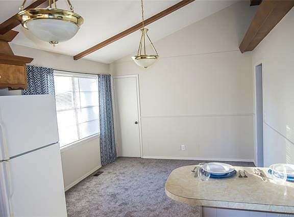 Dining: As seen from kitchen- The multi functional peninsula counter serves as cozy seating, serving buffet and additional counter space.