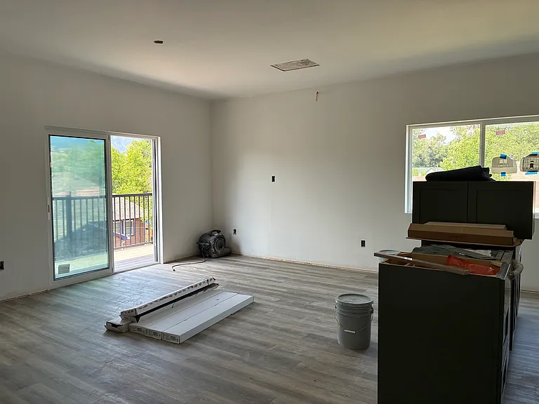 Living and kitchen space with access to balcony.