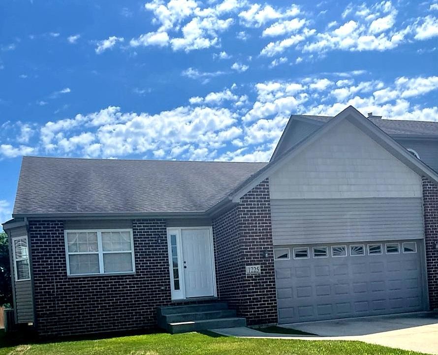 Exterior of home. Large 2 car garage with concrete driveway