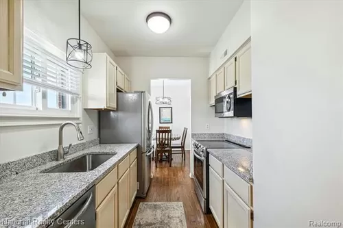 The kitchen was refreshed in 2024 with brand-new stainless steel appliances and granite countertops with plenty of natural light - 33135 Orchard St #15
