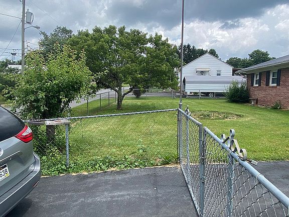 Fenced yard from driveway   
