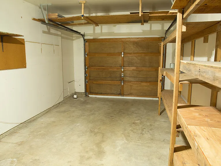Attached 1-car garage with built-in shelving and additional storage space. Convenient off-street parking and flexible room for storage or hobbies.