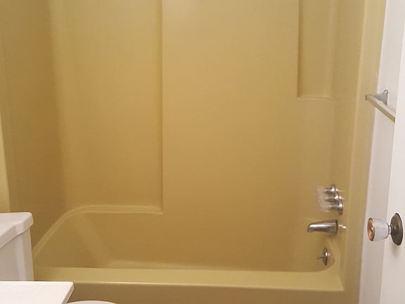 Convenient bathroom with both shower and tub, vanity include
