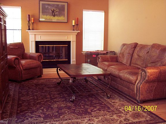 Family room with fireplace.  View is from kitchen/breakfast room area.