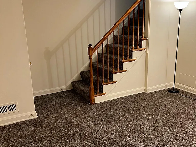 stairs to upper level from living room