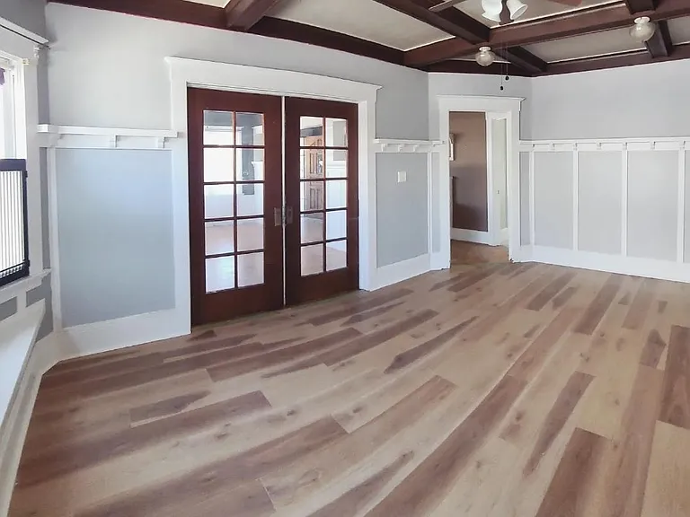 Large dining room or family room with double pocket doors leading to formal living room. Exposed beams and ceiling details and woodworking, built-ins, etc. So much character!