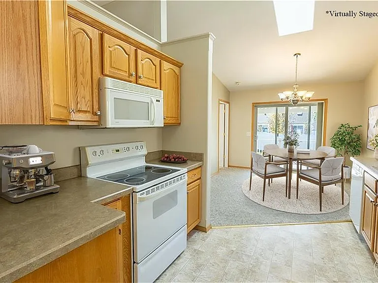 Looking from the garage door to the dining room, staged