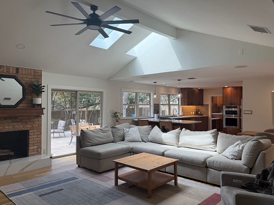 Large living area with vaulted ceilings and two skylights