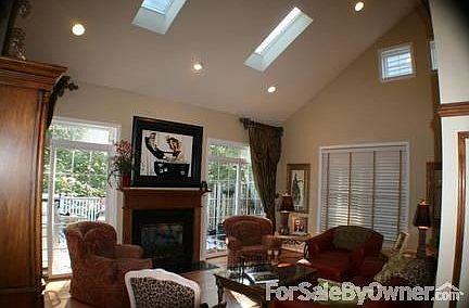 Living Area with lots of natural light
						:
						French doors lead to extra large deck backing to beautiful woods, F/P w/blower.