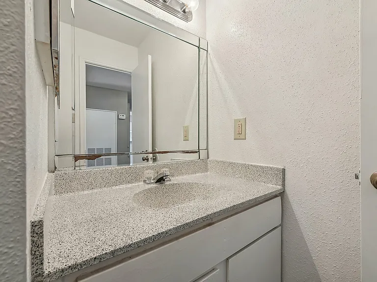 Bathroom vanity with a sleek countertop at Driscoll Place Apartments.