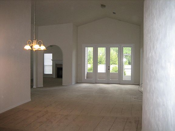 High-ceiling dining area and living room together (viewed from entrance area looking to back door).
