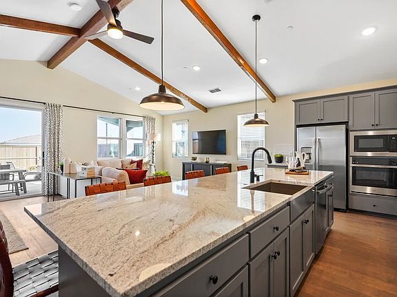 Kitchen with vaulted ceiling and stained ceiling beams