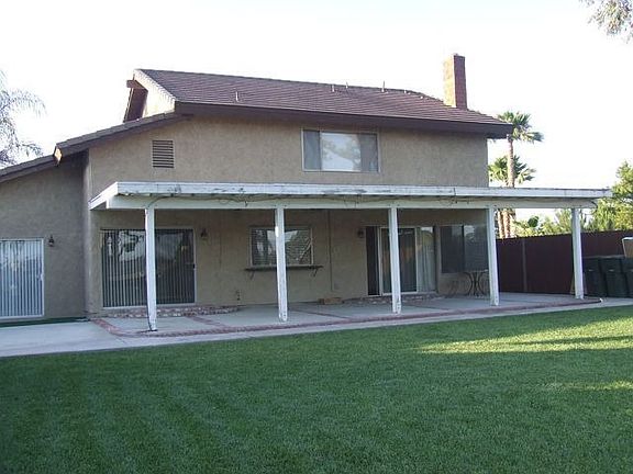 large covered patio, lush lawn