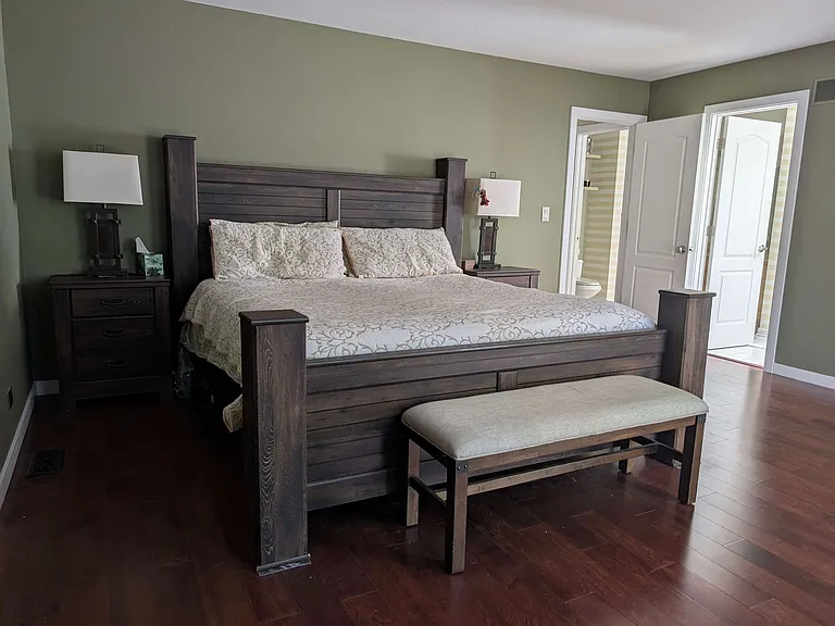 A very spacious master bedroom, with a balcony, walk-in closet, and a dedicated bedroom entrance