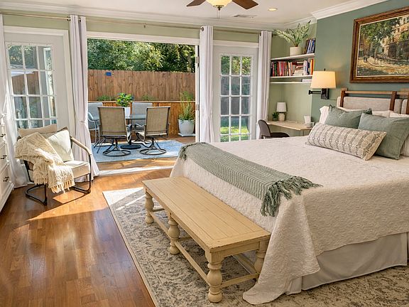 Master Bedroom: French doors open to the deck / outdoor dining table. Shade umbrella stored in garage.