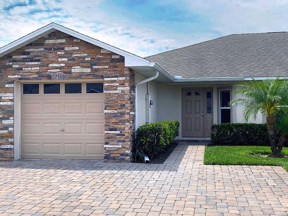 Wide paver driveway with 1 car garage.