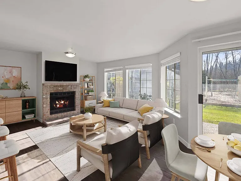Step into a sunlit living room with large windows and direct access to the outdoors, perfect for seamless indoor outdoor living