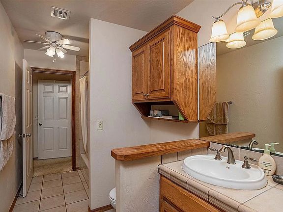 Shared bathroom, from hall doorway. Doorway at end of bathroom adjoins the smaller of the two rental rooms.