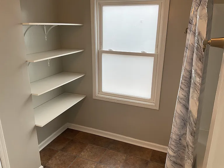Main Floor Bath Storage Shelves are great for extra towels and sheets.