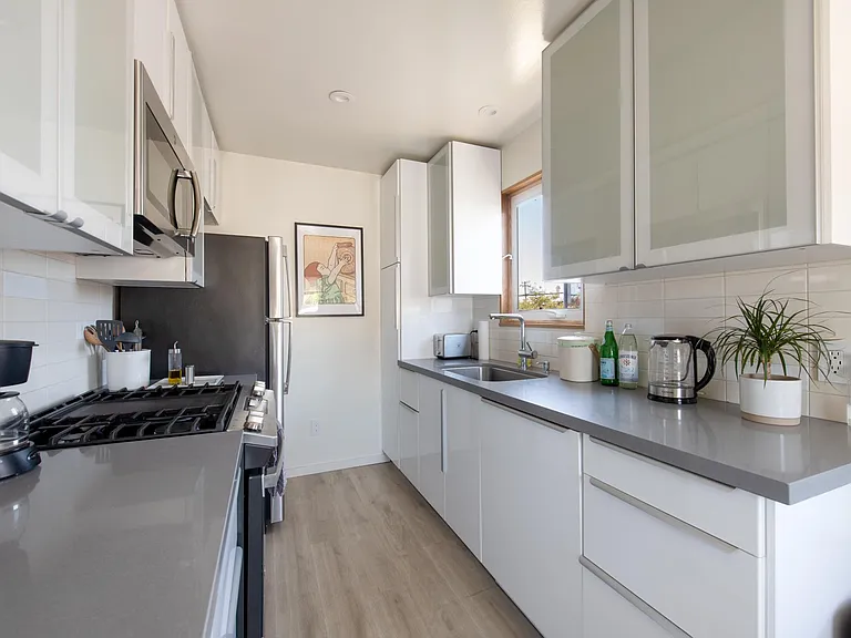 A kitchen equipped with modern appliances (including a dishwasher) and plenty of storage space!