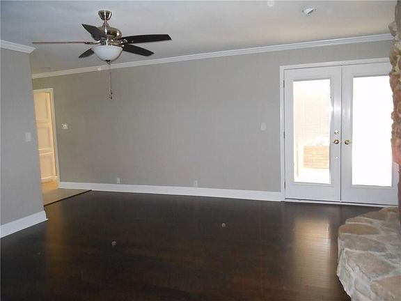 Family Room with rock fireplace and frendh doors to the patio.