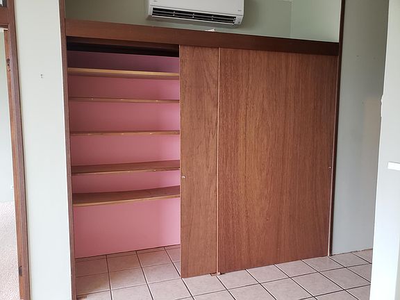 Storage in living room. Split AC above.