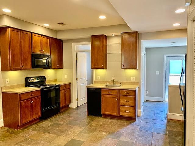 Kitchen, laundry and door to back yard on left, powder bath on right