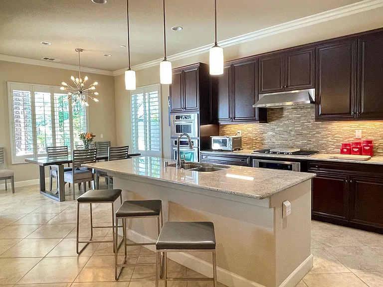 Chef's kitchen including all necessary tools & hardware for better than restaurant entertaining featuring quality stainless appliances all topped with beautiful granite counters and 3-4 counter stools for informal dining or distracting the cook!