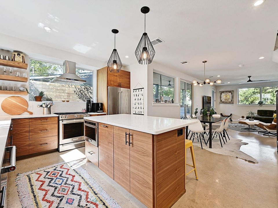 Beautiful walnut cabinets and a sleek very thought out design make this kitchen both warm inviting yet stylish and modern.