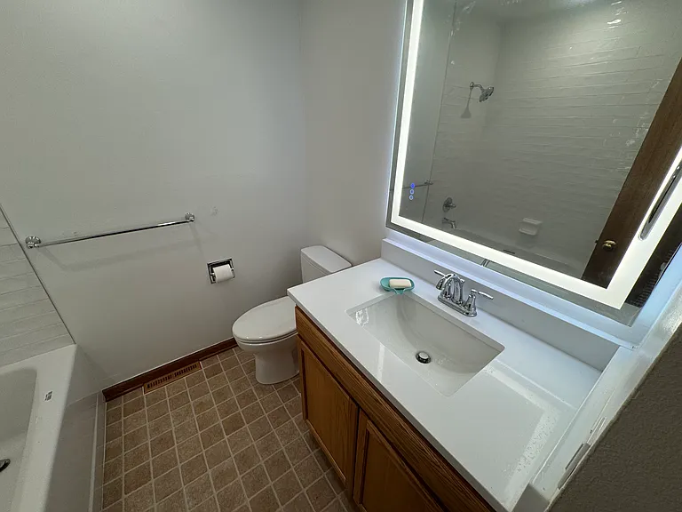 Main bathroom all new Toto lavatory, quartz countertops, fog free mirror with active lightening front and back light, new flooring and larger tub. All new Delta faucets.