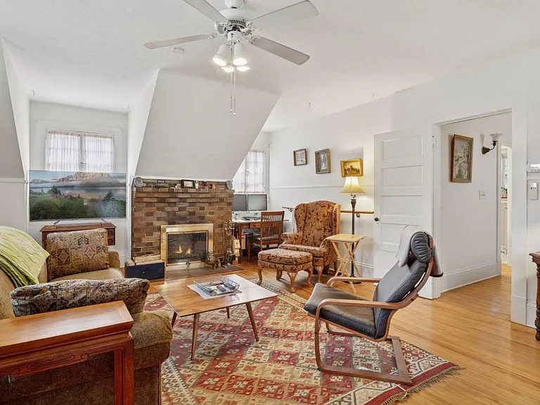 Bright living space - with active, functional wood-burning brick fireplace, north + south + east facing windows for tons of natural light, ceiling fan for well circulated air, and plenty of space for hosting, dining, exercise, working, etc.