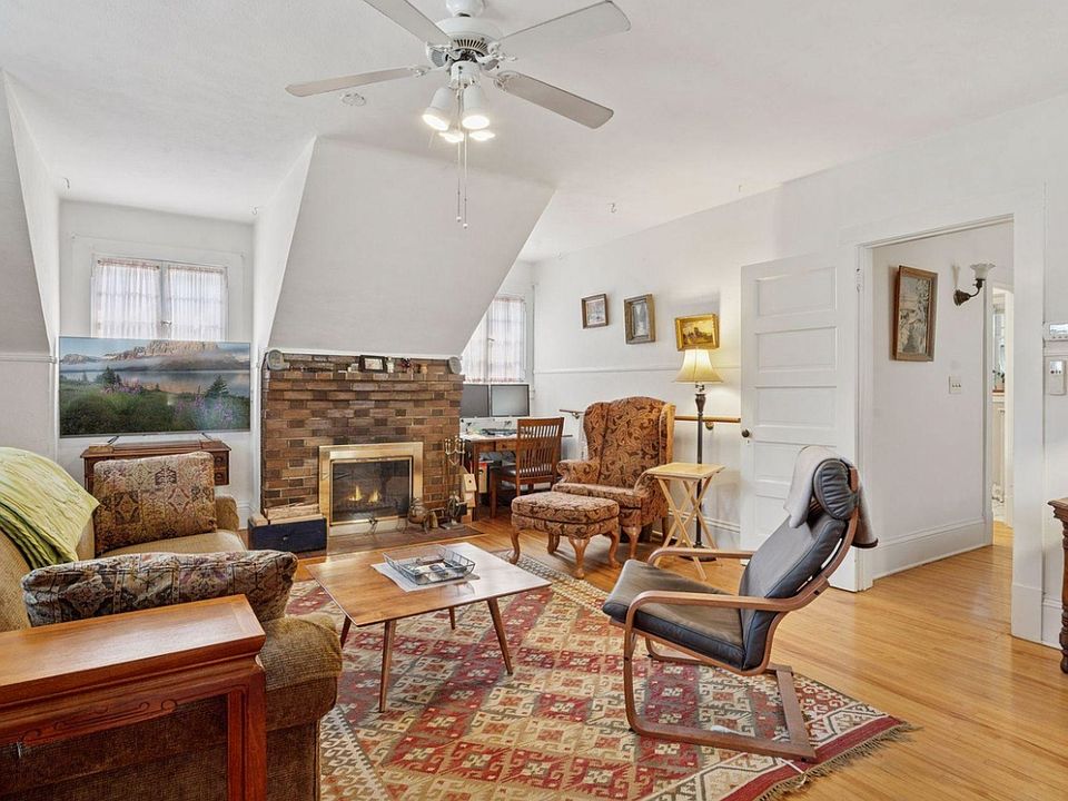 Bright living space - with active, functional wood-burning brick fireplace, north + south + east facing windows for tons of natural light, ceiling fan for well circulated air, and plenty of space for hosting, dining, exercise, working, etc.