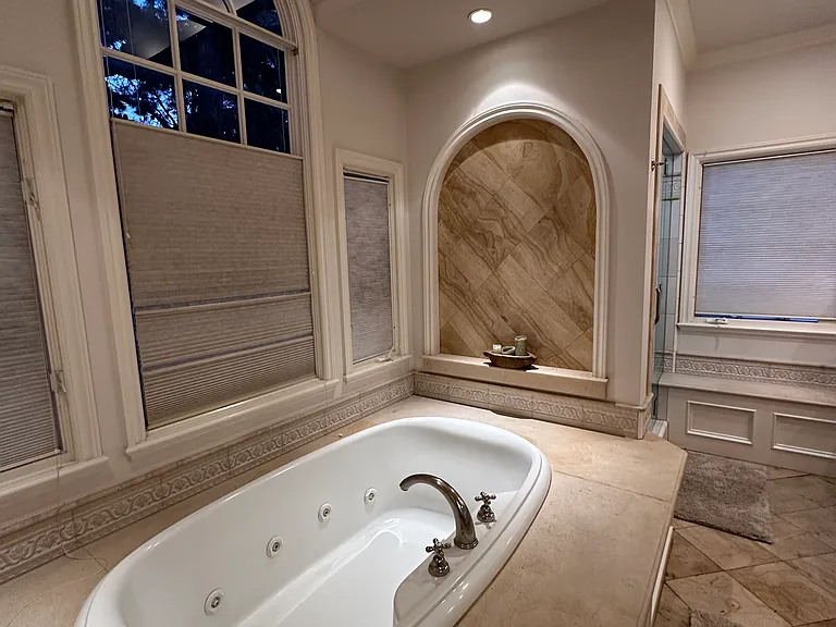 Primary bathroom suite includes jetted tub