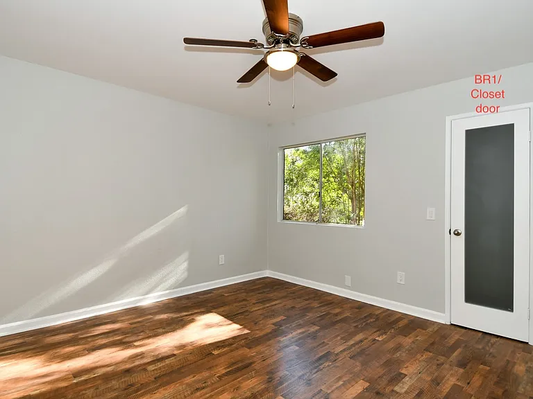 Bedroom 1 with walk-in closet. Vertical blinds have been installed