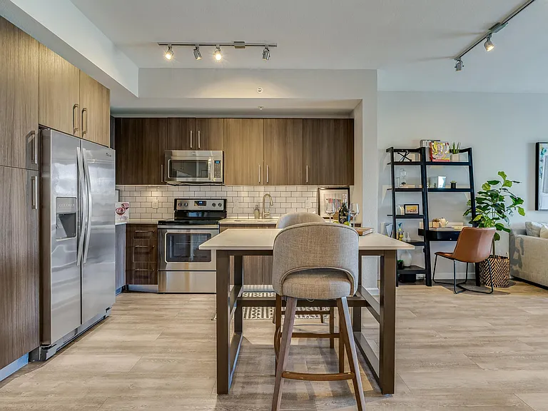Open Kitchen with Island Seating and View into Living Room
