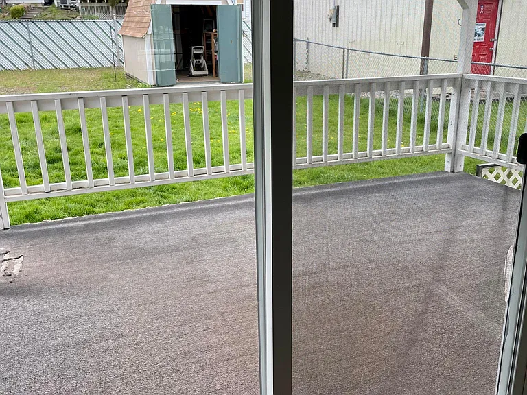 Slider to the covered deck and fenced backyard