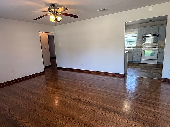 Looking through the front door to the rear of the living room.The bedrooms and bathroom are through to the left. Kitchen straight ahead, and dining room/Florida room to the right. Nice Hardwood Floors!